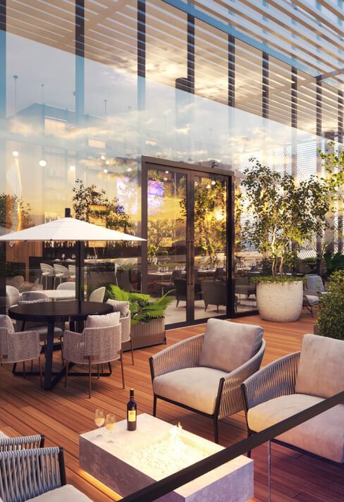 Terraço do Club House com toda a divisória da área externa e interna em vidro. O deck de madeira combina perfeitamente com a decoração de alto padrão e a integração com a natureza viva do ambiente.